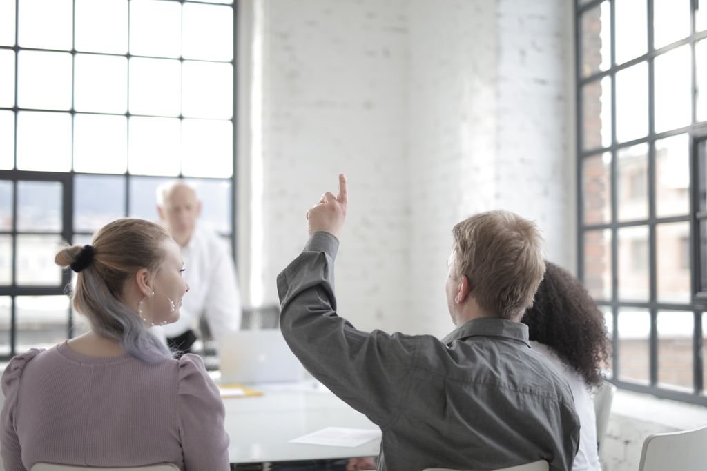 Colleagues engaged in a collaborative discussion in a bright, modern office setting.
